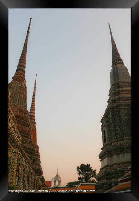 Second view of two stupa against sky at Wat Pho Framed Print by Hanif Setiawan