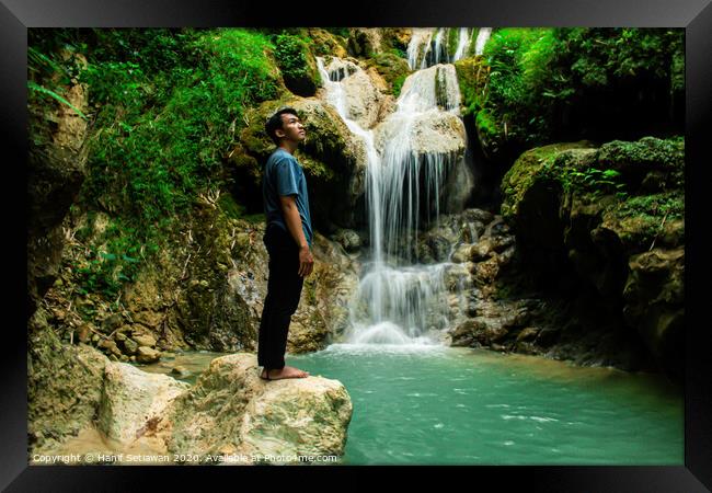 Young man enjoys the waterfall Mudal Framed Print by Hanif Setiawan