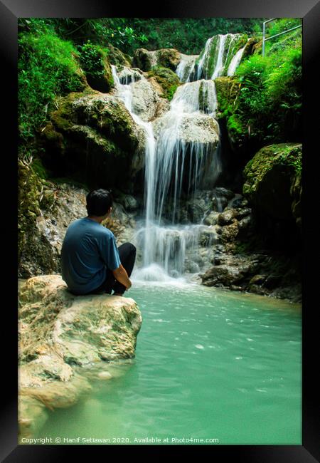 Young man enjoys the waterfall Mudal 2 Framed Print by Hanif Setiawan