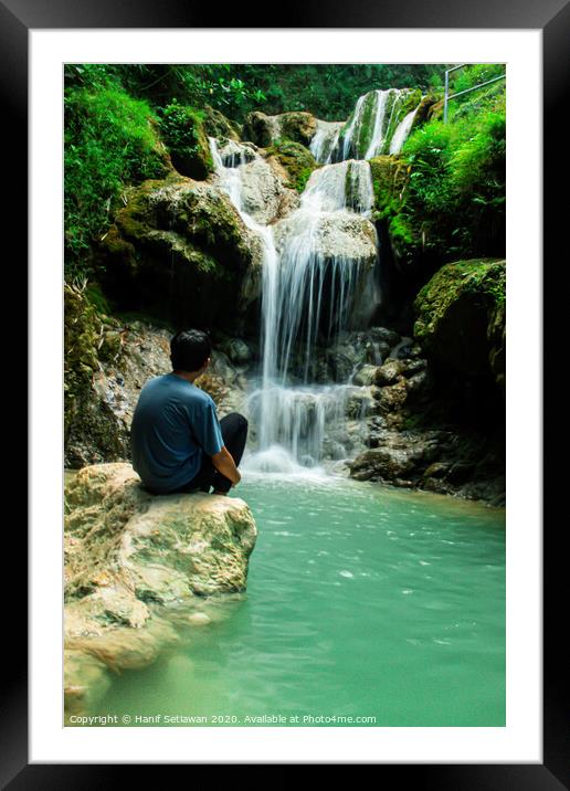 Young man enjoys the waterfall Mudal 2 Framed Mounted Print by Hanif Setiawan