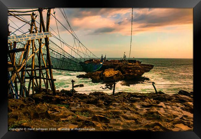 Rock island connected by rope foot bridge Framed Print by Hanif Setiawan