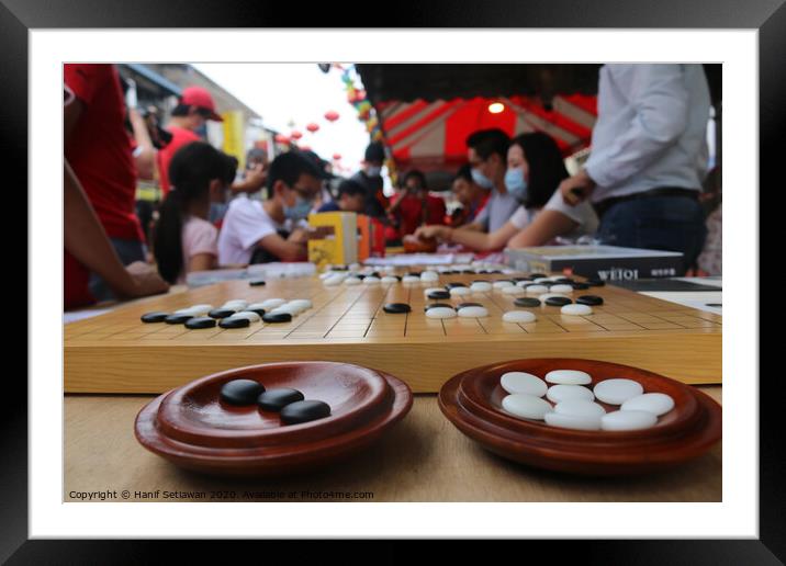 Chinese playing Go Game, Weiqi in a street. Framed Mounted Print by Hanif Setiawan