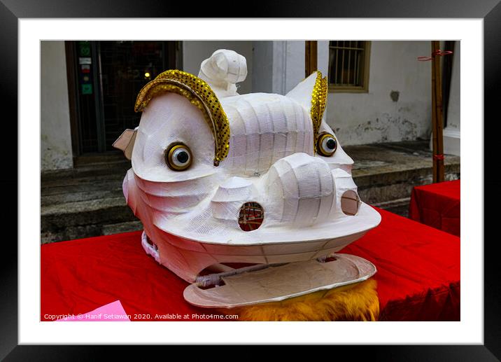 Unfinished white Chinese Dragon mask on a festival Framed Mounted Print by Hanif Setiawan
