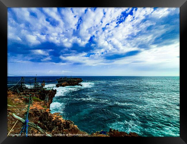 A rock plateau and a rock island in the sea Framed Print by Hanif Setiawan