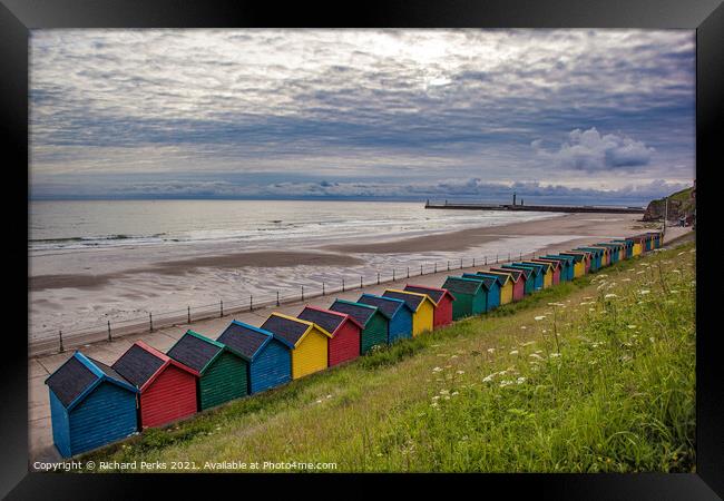 Whitby Beach huts waiting for the storm Framed Print by Richard Perks
