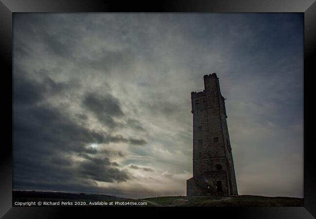 Majestic Castle Hill Tower Amidst Rolling Clouds Framed Print by Richard Perks