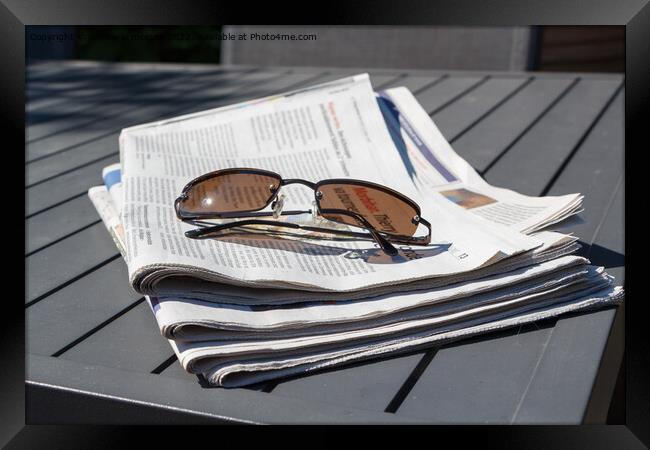 Pile of newspapers and sunglasses Framed Print by aurélie le moigne