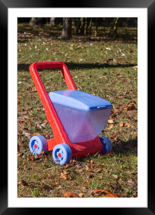 Red and blue wheelbarrow in plastic Framed Mounted Print by aurélie le moigne