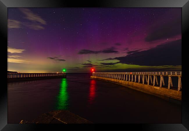 Northern Lights over the piers in Whitby Framed Print by Kevin Winter