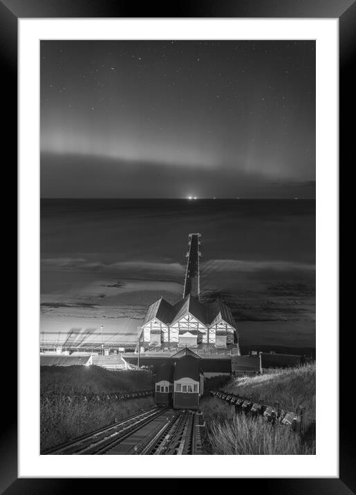 Aurora Borealis over Saltburn pier in Black and white Framed Mounted Print by Kevin Winter