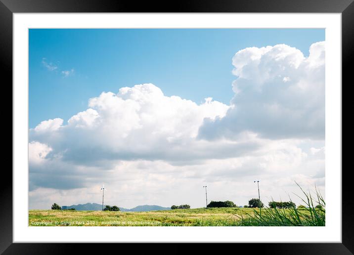 Green field and cloudy sky Framed Mounted Print by Sanga Park