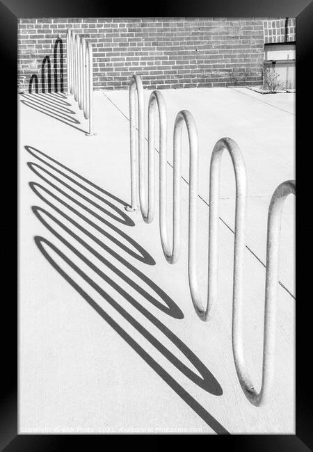 Bike rack shadows cast form abstract shapes on concrete Framed Print by Blok Photo 