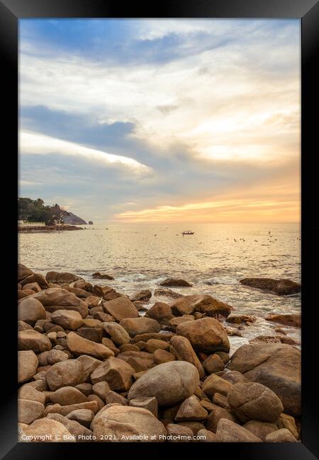 Dramatic Setting Sun and Rocky Shore  Framed Print by Blok Photo 