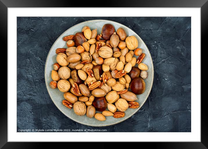 Assortment of nuts on a plate Framed Mounted Print by Mykola Lunov Mykola