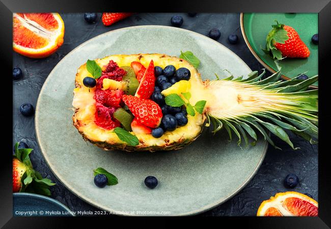 Fruit salad in half a pineapple, vegan concept. Framed Print by Mykola Lunov Mykola