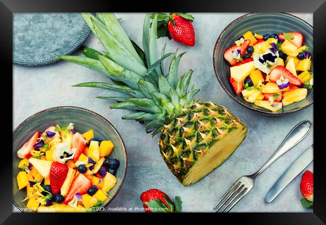 Bright fruit salad with edible flowers. Framed Print by Mykola Lunov Mykola