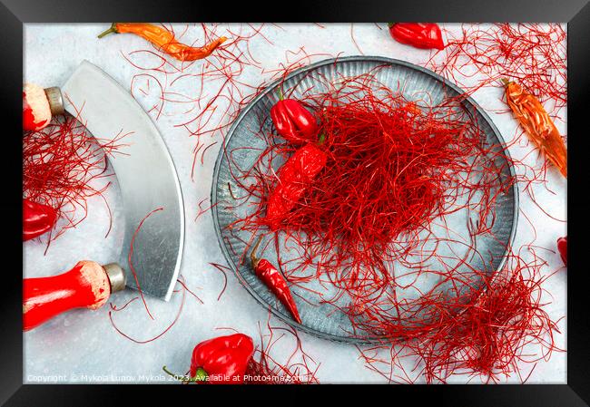 Cutting red chilly peppers. Framed Print by Mykola Lunov Mykola