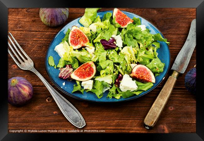 Salad with figs, herbs and cheese on wooden table. Framed Print by Mykola Lunov Mykola