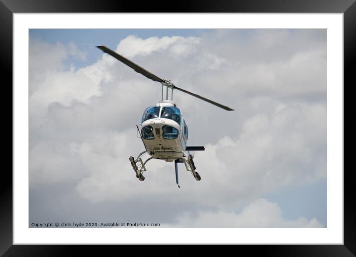helicopter under cumulous clouds Framed Mounted Print by chris hyde