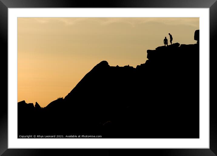 Two rock climbers look back from the summit of stanage edge in england Framed Mounted Print by Rhys Leonard