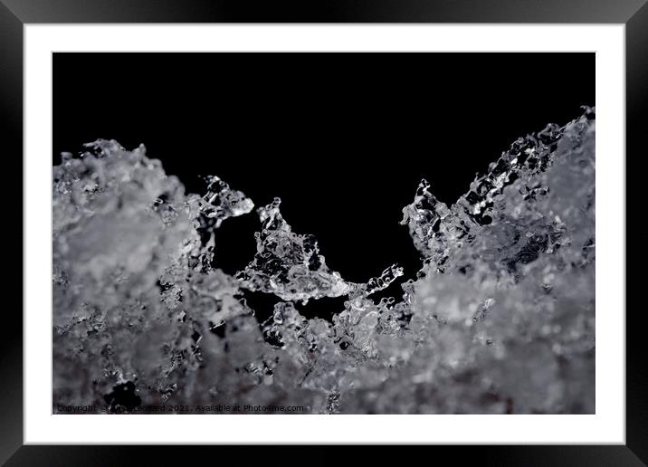 Intricate details of melting ice particles, focus on odd ice crystal Framed Mounted Print by Rhys Leonard