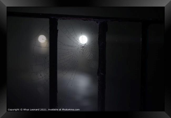 Spooky night time fog around a cobweb under railings with dew on it Framed Print by Rhys Leonard