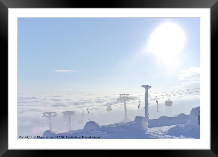 T-bar and gondola lifts emerge through the clouds into the sun Framed Mounted Print by Rhys Leonard