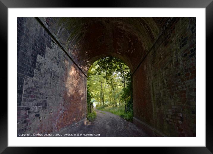 Red brick tunnel contains a muddy double-track lane Framed Mounted Print by Rhys Leonard
