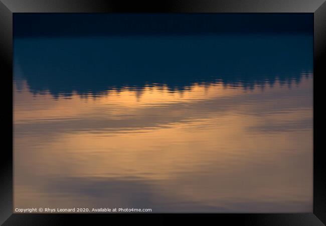 Reflection of sunset colors over trees in calm rippled water Framed Print by Rhys Leonard