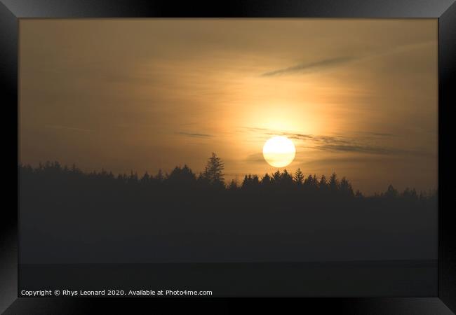 Redmires reservoirs coniferous forest slihouetted at sunset Framed Print by Rhys Leonard