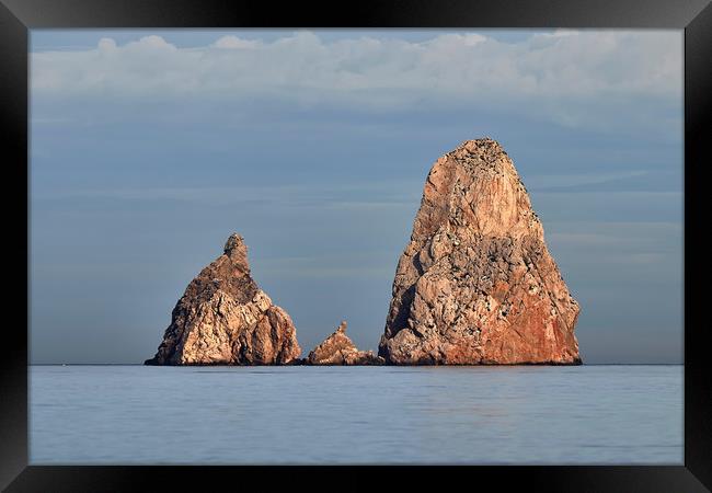 Rocks on the ocean Framed Print by Arpad Radoczy