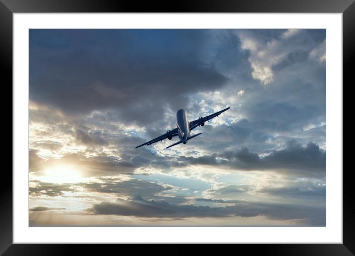 Passenger airplane on a cloudy sky Framed Mounted Print by Arpad Radoczy
