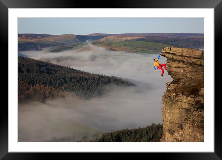 A rock climber free climbing on bamford edge in th Framed Mounted Print by MIKE HUTTON