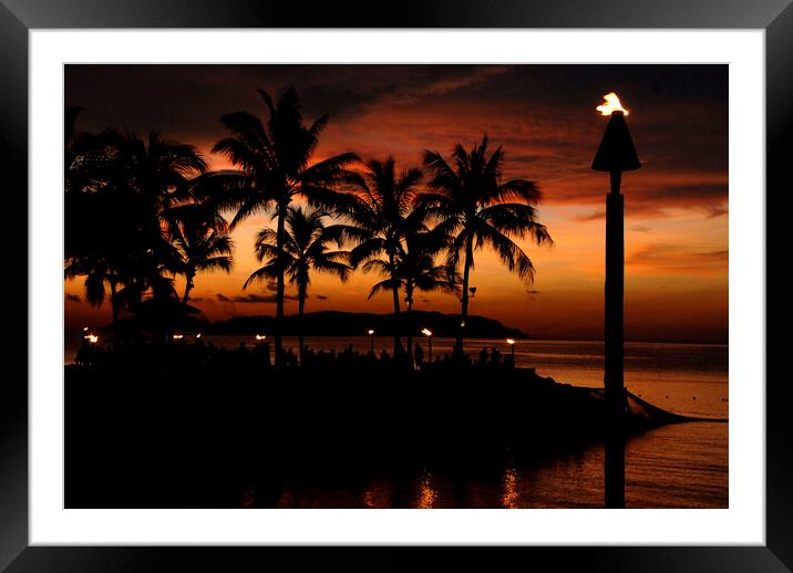 A red sunset over ocean shore in front of a palm tree Framed Mounted Print by Alessandro Della Torre