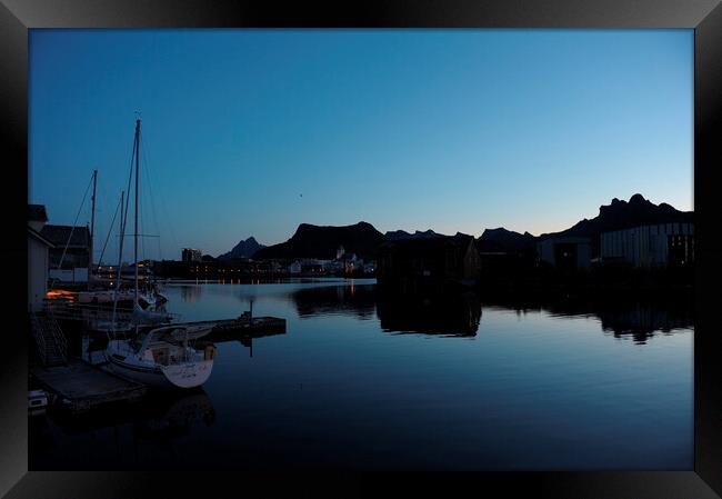 A boat is docked in a harbor at the blue hour, in a fjord Framed Print by Alessandro Della Torre