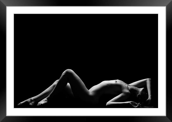 a woman nude and naked in fine art photography bodyscape laying on black studio background Framed Mounted Print by Alessandro Della Torre