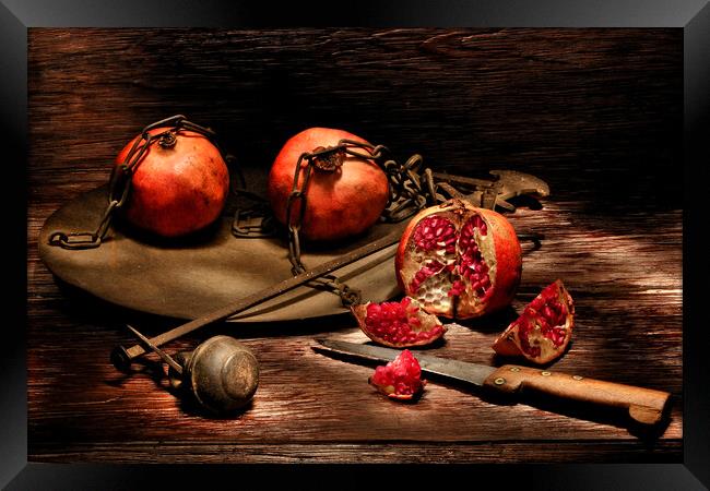 Pomegranates on a wooden table Framed Print by Alessandro Della Torre