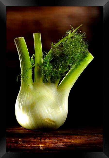 a green fennel on a wood table Framed Print by Alessandro Della Torre