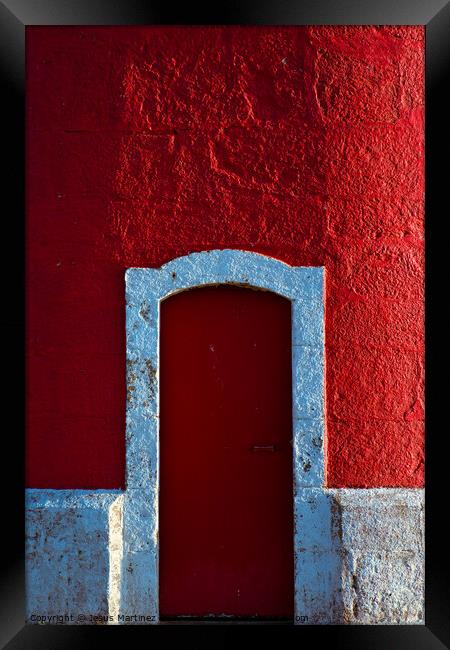 The Alluring Red Door Framed Print by Jesus Martínez