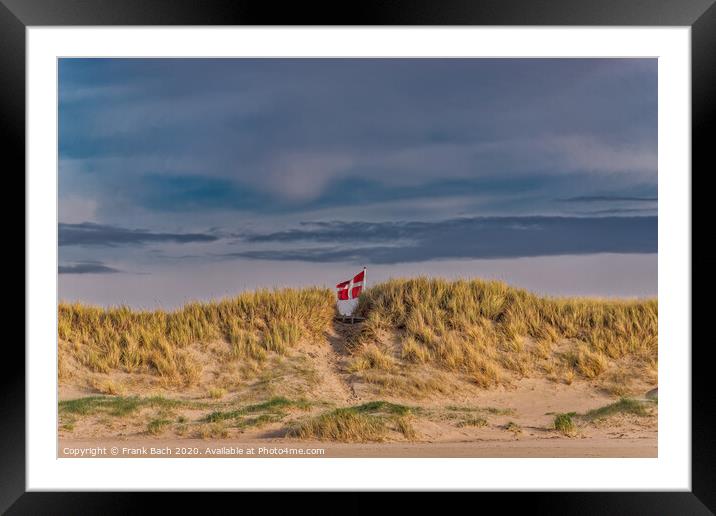 Danish flag waving behind dunes on Blaavand Beach, Denmark Framed Mounted Print by Frank Bach