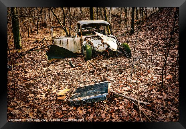 Car wreck desolated worn and rusty left in a forest, Denmark Framed Print by Frank Bach