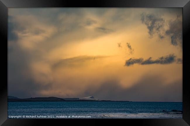 Storm clouds over a snowy Noss in Shetland Framed Print by Richard Ashbee