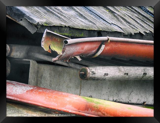 Closeup shot of a rusty pipe under the weathered roof Framed Print by Ingo Menhard