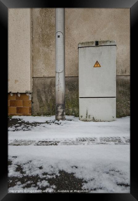 Vertical of an electricity control box on the snowy road Framed Print by Ingo Menhard