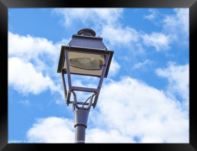 A low angle shot of an old metal street lamp against blue cloudy sky Framed Print by Ingo Menhard
