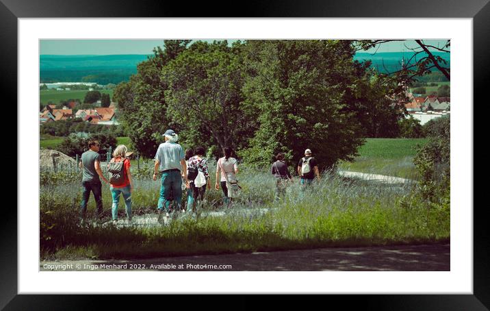 Group of wanderers at the Friedrichsberg in Bavaria walking to the village of Abtswind Framed Mounted Print by Ingo Menhard