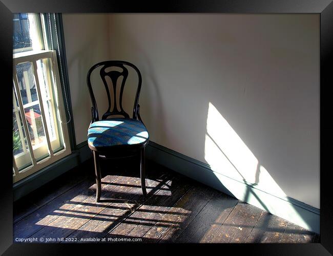 Chair in a empty room. Framed Print by john hill