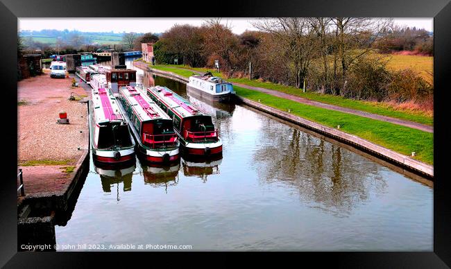Barges and narrow boats berthed . Framed Print by john hill