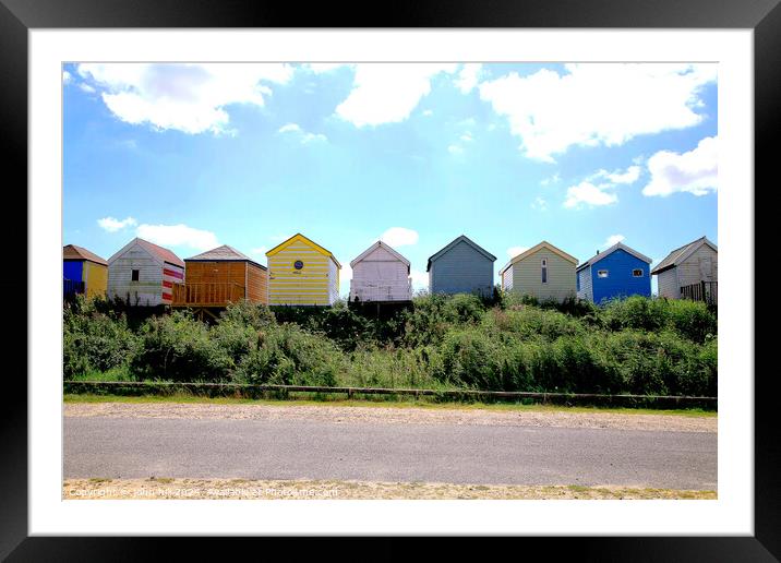 Silhouetted beach huts at Chapel point. Framed Mounted Print by john hill