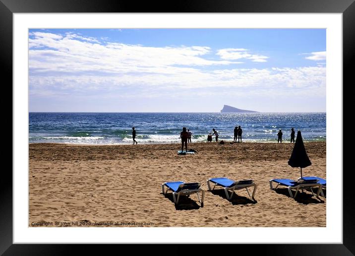 Silhouettes against the mediterranean at Benidorm in Spain. Framed Mounted Print by john hill
